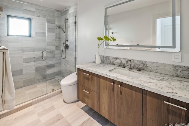 bathroom with tile patterned floors, vanity, an enclosed shower, and toilet