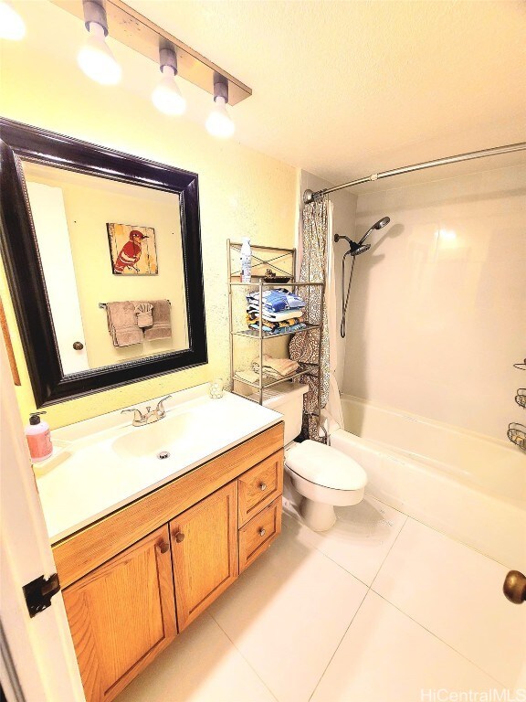 full bathroom with toilet, vanity, tile patterned floors, and shower / bathtub combination with curtain