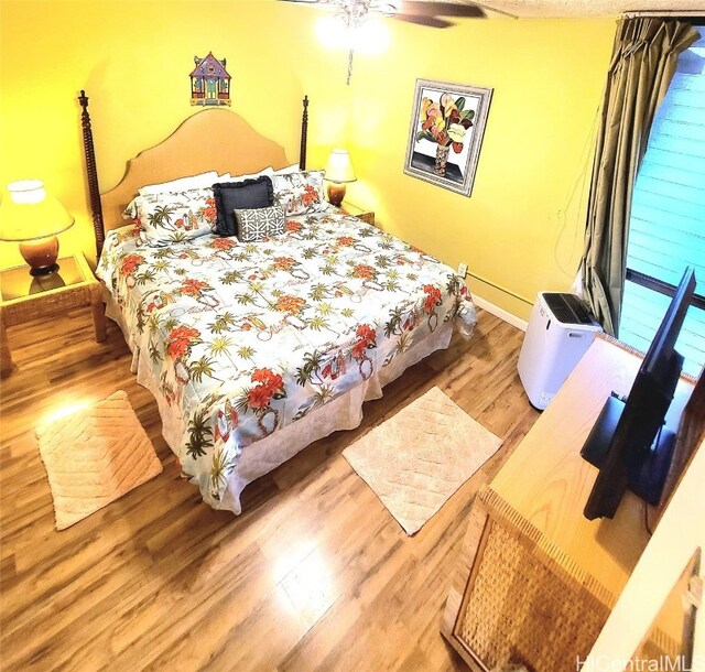 bedroom featuring hardwood / wood-style floors and ceiling fan