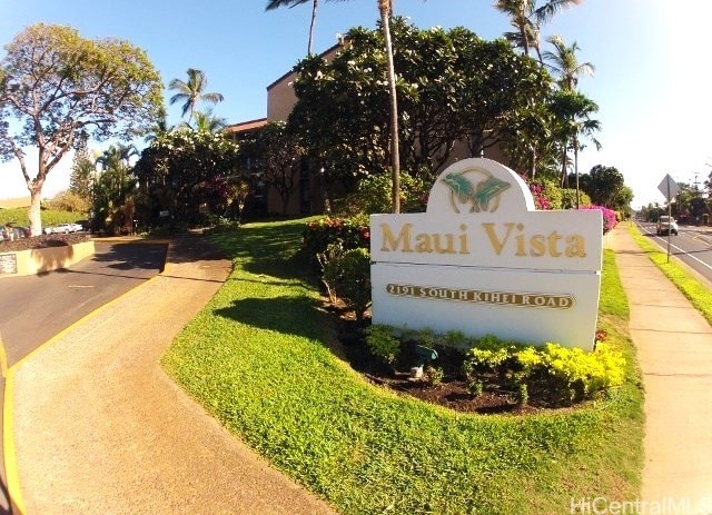 community / neighborhood sign featuring a lawn