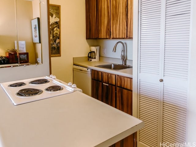 kitchen featuring white appliances and sink