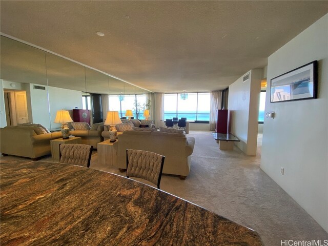 carpeted dining space with a textured ceiling