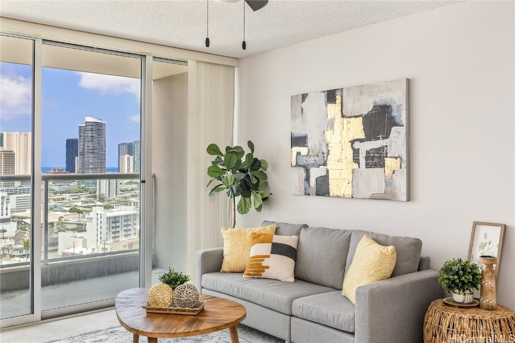 living room with a healthy amount of sunlight, a textured ceiling, and floor to ceiling windows