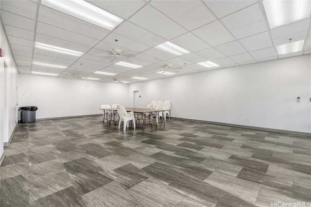 unfurnished dining area with a paneled ceiling and ceiling fan