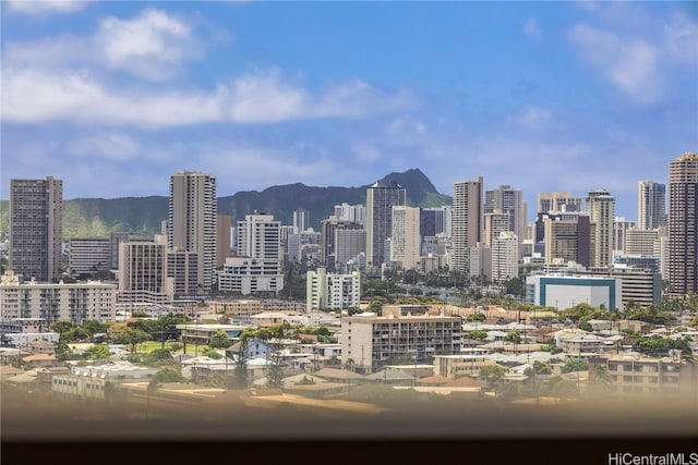 property's view of city with a mountain view