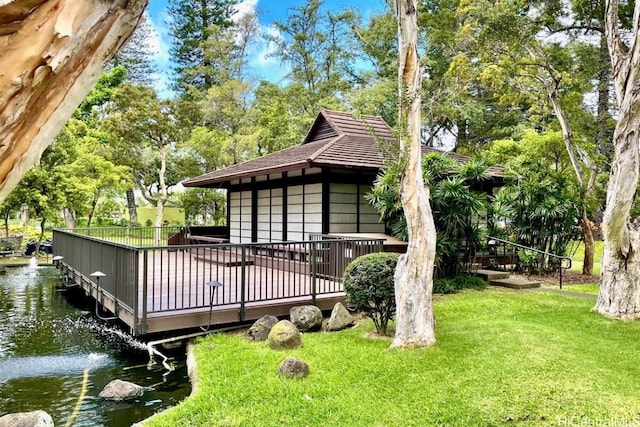 exterior space featuring a yard, a deck, and central air condition unit