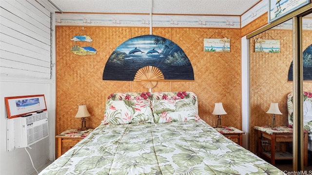 bedroom featuring a closet, a textured ceiling, ornamental molding, and cooling unit