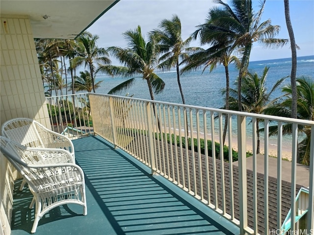 balcony with a water view and a beach view