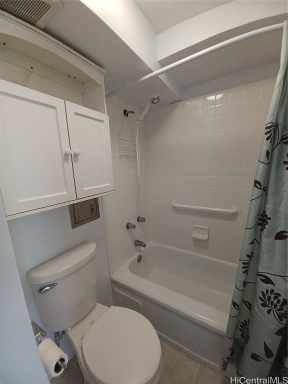 bathroom featuring shower / bath combo with shower curtain, toilet, and tile patterned flooring