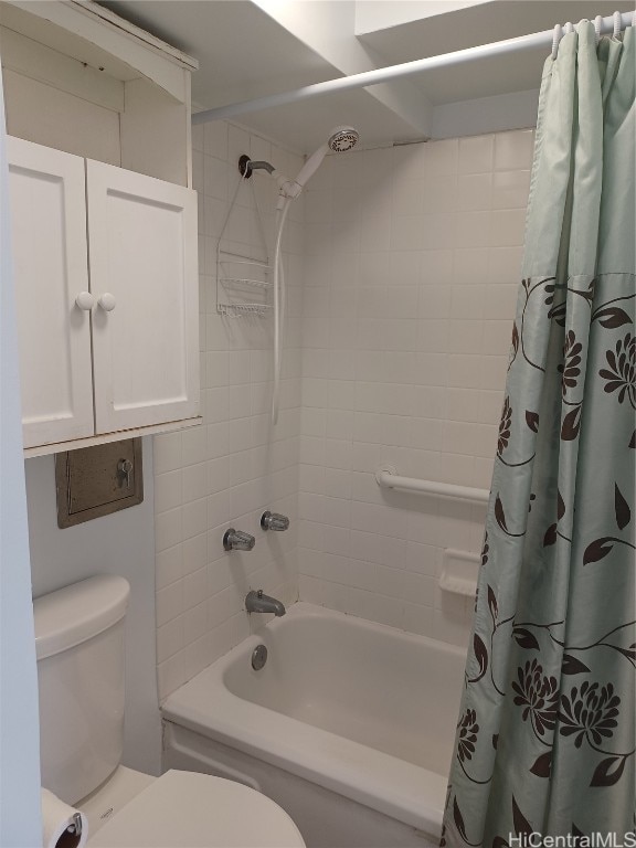 bathroom featuring shower / bath combo and toilet