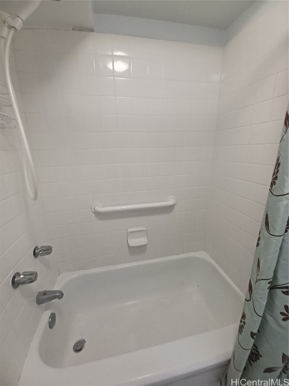 bathroom with shower / bath combo with shower curtain