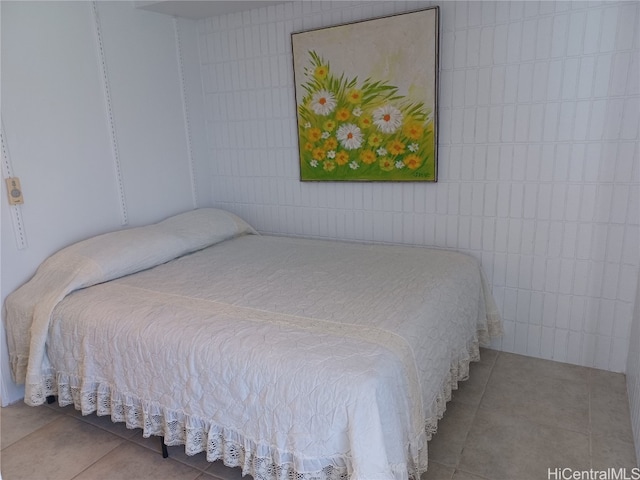 bedroom with tile walls and tile patterned flooring