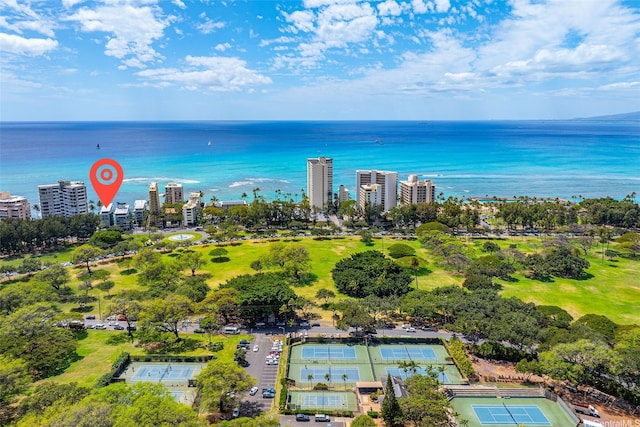 aerial view featuring a city view, view of golf course, and a water view