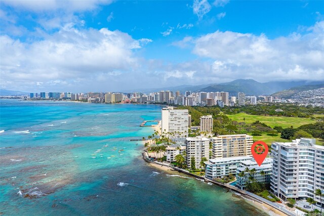 property view of water with a view of the beach, a mountain view, and a view of city