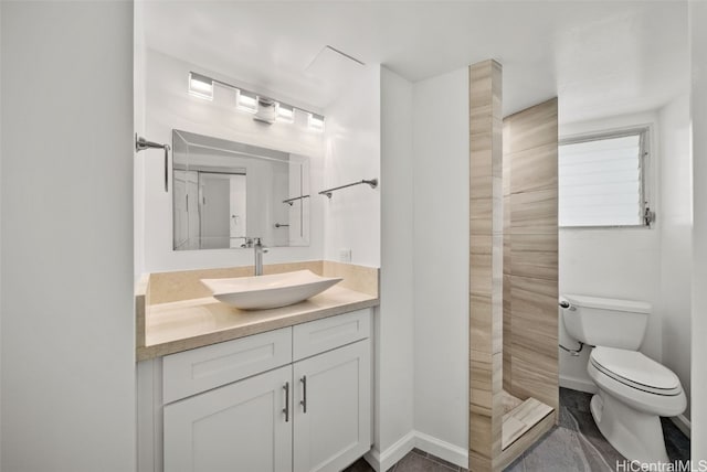 bathroom with vanity, toilet, and a shower