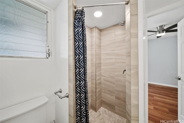 bathroom featuring toilet, wood-type flooring, a shower with curtain, and ceiling fan