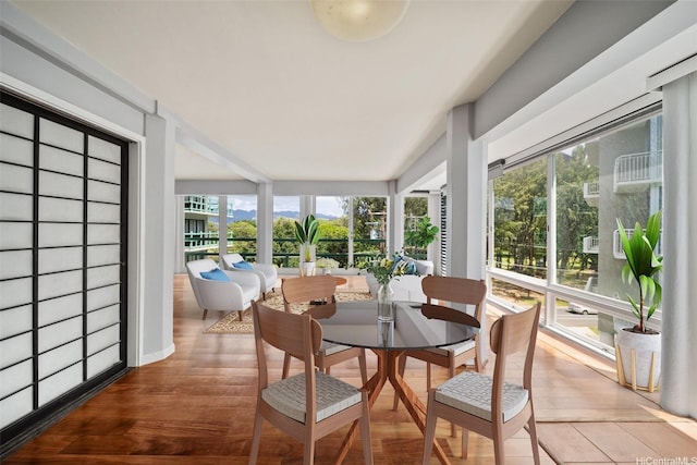 sunroom / solarium with wood finished floors and a healthy amount of sunlight