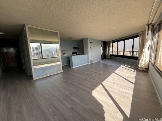 interior space featuring a textured ceiling and light hardwood / wood-style floors