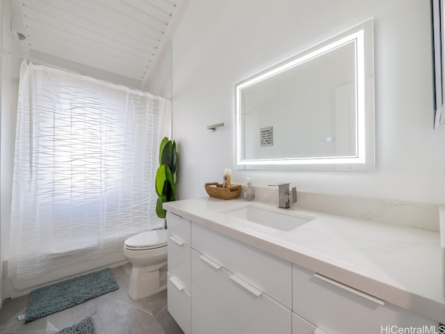 bathroom with toilet, lofted ceiling, vanity, and tile patterned floors