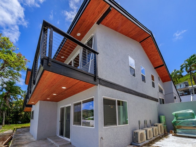 view of side of property with ac unit and a patio