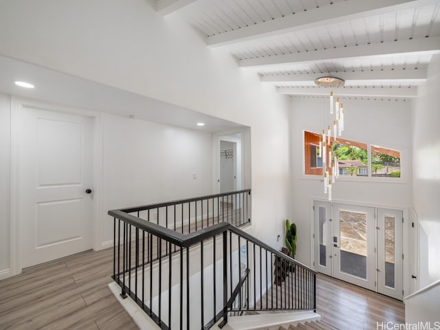 interior space featuring an inviting chandelier, hardwood / wood-style floors, and beam ceiling