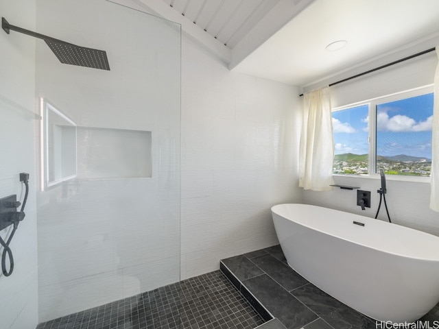 bathroom featuring independent shower and bath, lofted ceiling, and tile patterned flooring