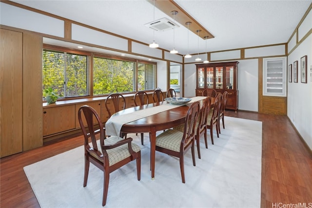 dining space with wood-type flooring