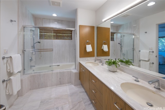 bathroom featuring vanity and bath / shower combo with glass door