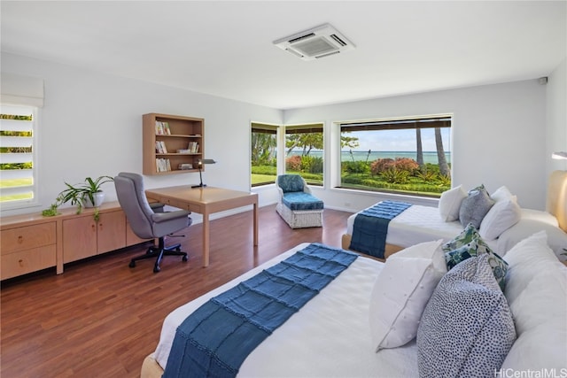 bedroom with dark wood-type flooring