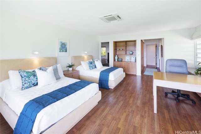 bedroom with dark hardwood / wood-style floors