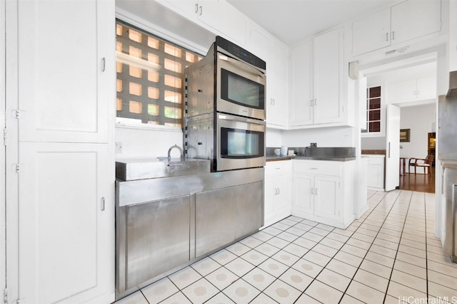 kitchen featuring white cabinets and light tile patterned floors