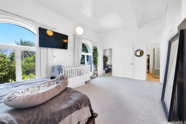 carpeted bedroom featuring beam ceiling