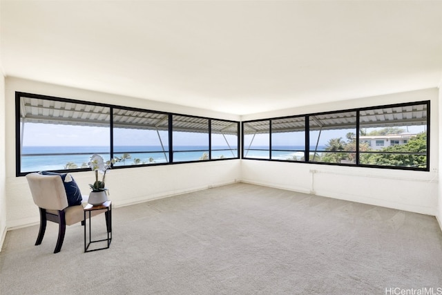 unfurnished sunroom with a water view