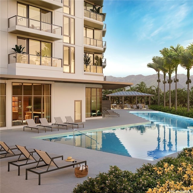 community pool featuring a patio area and a mountain view