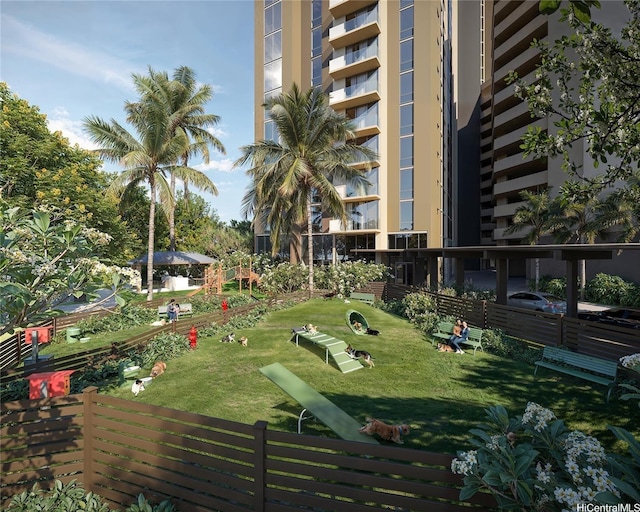 surrounding community featuring a lawn and fence