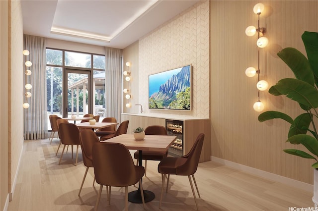 dining space with wallpapered walls, light wood-style flooring, baseboards, and beverage cooler