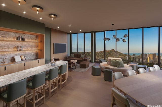 interior space featuring bar area and a wall of windows