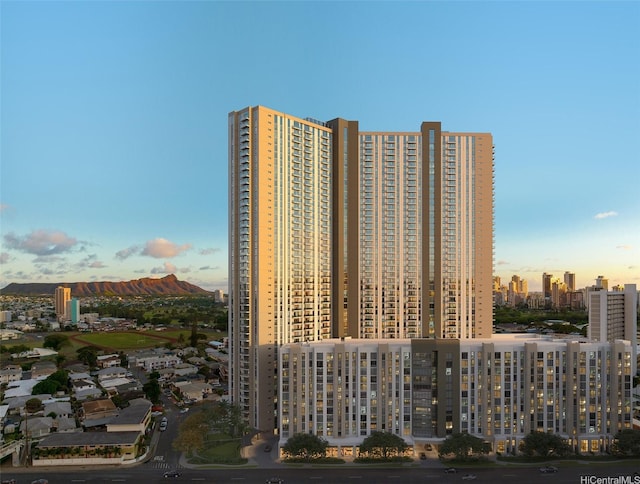 property at dusk featuring a city view