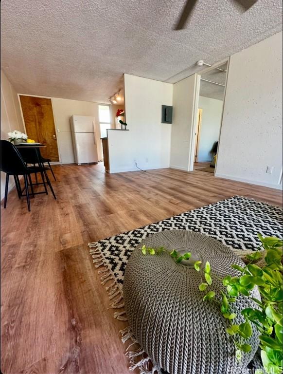 interior space with hardwood / wood-style floors and a textured ceiling