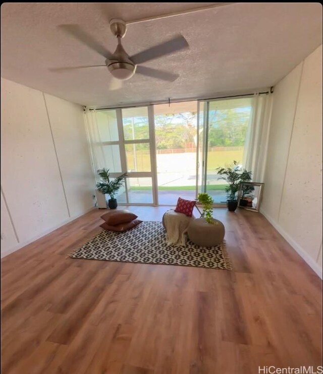 sunroom featuring ceiling fan