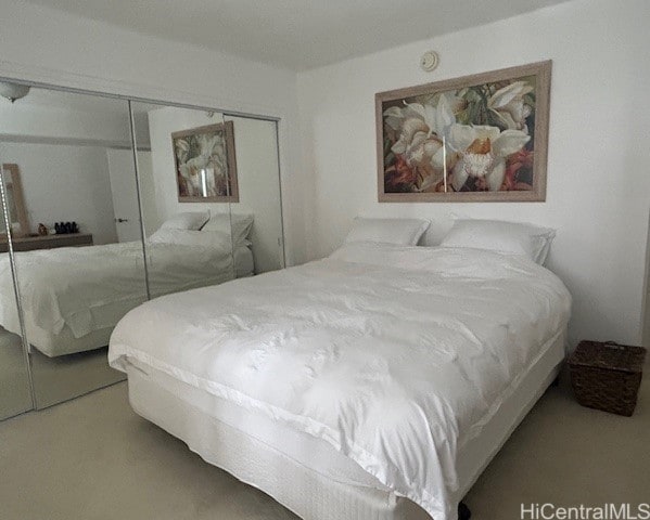 carpeted bedroom with a closet