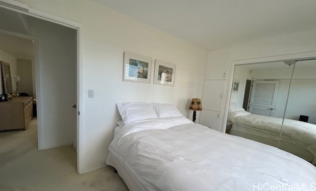 carpeted bedroom with a closet