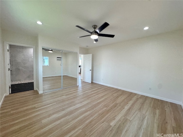 spare room with ceiling fan and light wood-type flooring