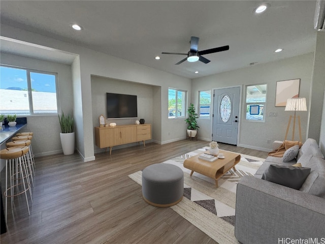 living room with wood-type flooring and ceiling fan