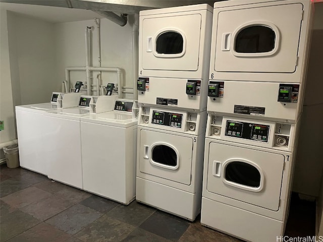 clothes washing area featuring stacked washer / drying machine and washer and clothes dryer