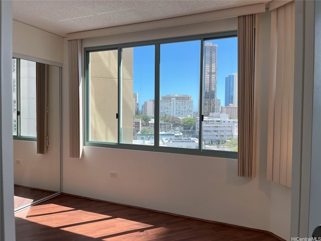 1314 Kalakaua Ave Unit 706, Honolulu, HI 96826 - empty room featuring a view of skyline and wood finished floors