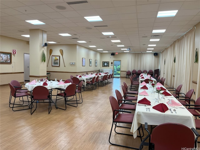 1314 Kalakaua Ave Unit 706, Honolulu, HI 96826 - dining space featuring light wood-type flooring, wainscoting, and a drop ceiling