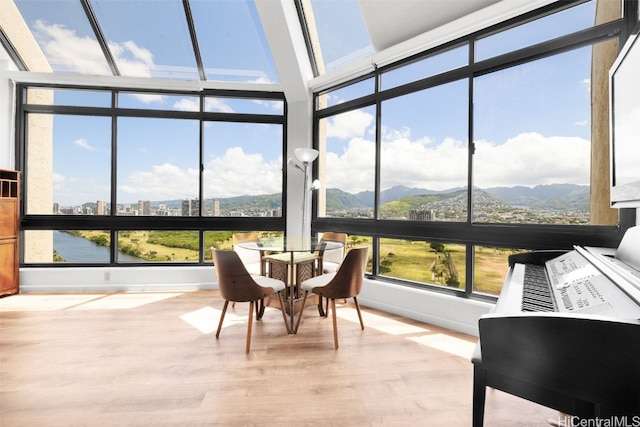 sunroom / solarium with a mountain view and plenty of natural light