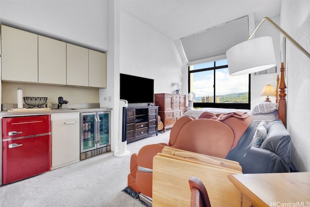 living room with lofted ceiling, light colored carpet, indoor bar, and beverage cooler