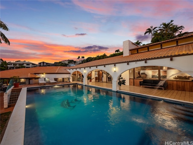 view of pool at dusk